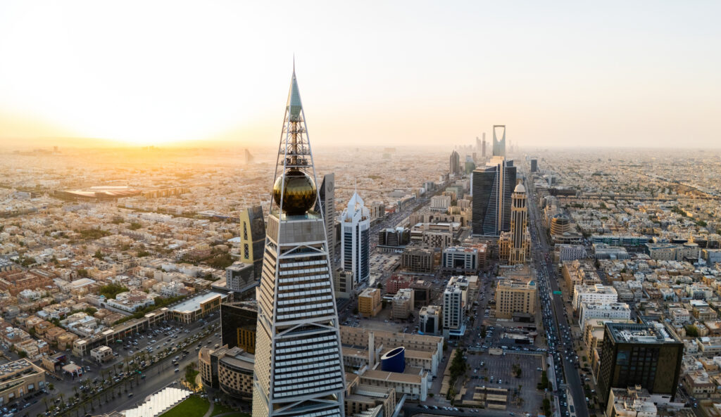Al Faisaliah Tower pyramid-shaped commercial skyscraper. Riyadh. Drone shot flying. Sunset. Evening
